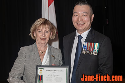 Paul Nguyen receiving the King Charles III Coronation Medal from MP Judy Sgro